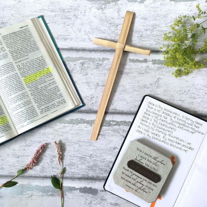 A Bible, a palm cross, a journal with the words of the first verse of 'Great is thy faithfulness' written on the inside front cover and a plaque with the words "'For I know the plans I have for you,' declares the Lord, 'plans to prosper you and not to harm you, plans to give you hope and a future' (Jeremiah 29:11)" and the word 'Journey'.
